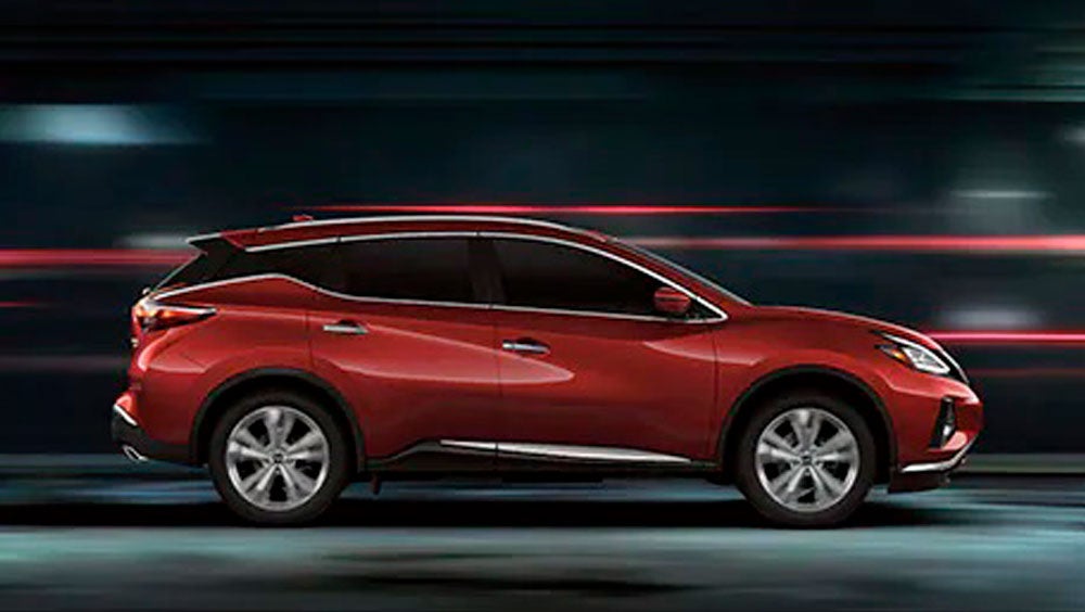 2023 Nissan Murano shown in profile driving down a street at night illustrating performance. | Supreme Nissan in Slidell LA